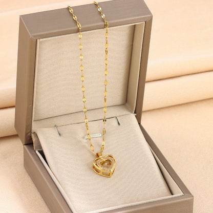 Gold heart-shaped necklace in an open jewelry box on a beige background Love heart pendant necklace for Valentine’s Day