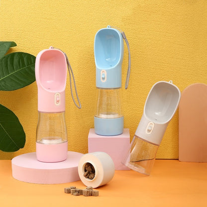 Three portable pet water bottles in pink, blue, and gray on a yellow background.