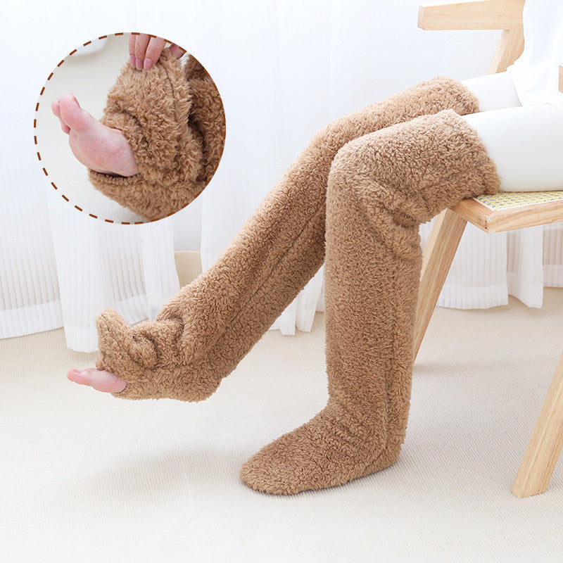 Person wearing brown fuzzy knee-high socks sitting on a chair.